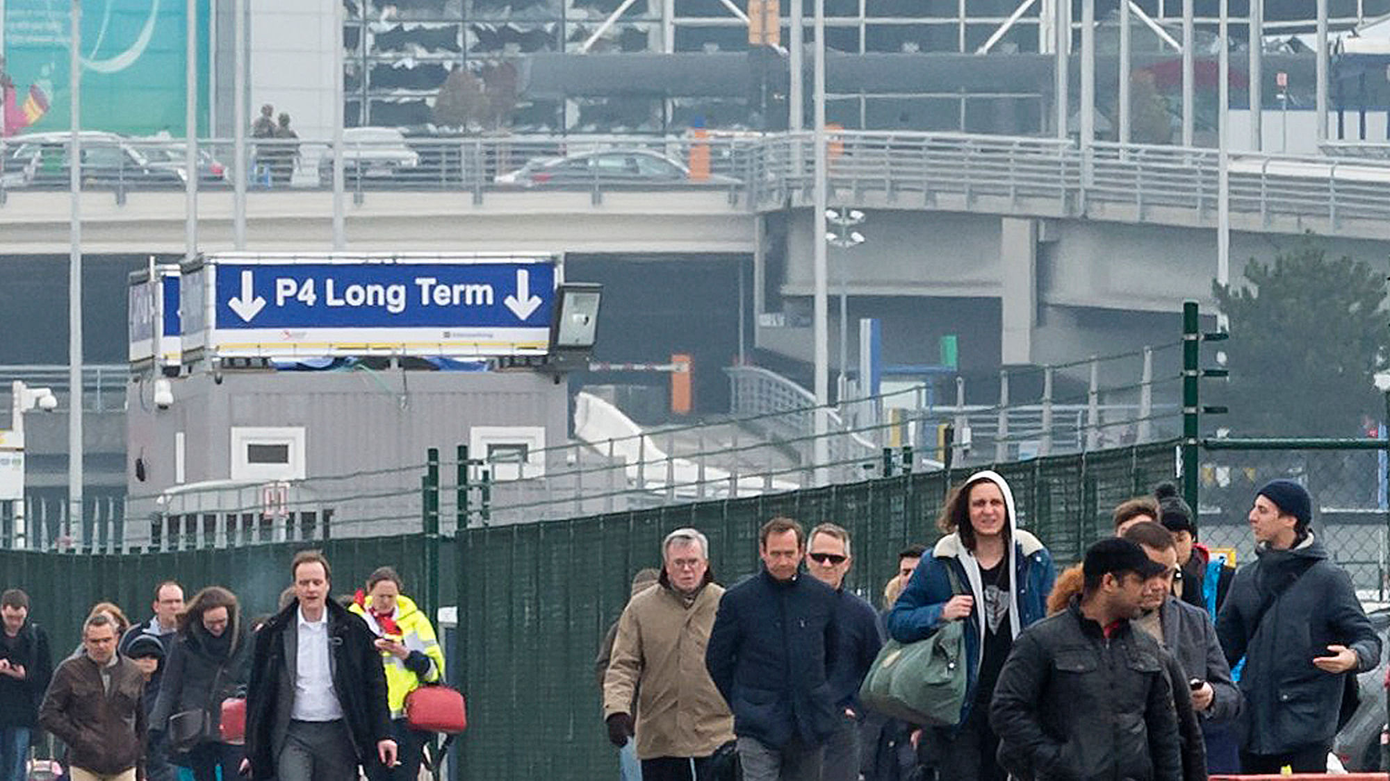 People walk away from the broken windows at Zaventem Airport in Brussels after an explosion on Tuesday, March 22, 2016.&nbsp;(Photo: AP)
