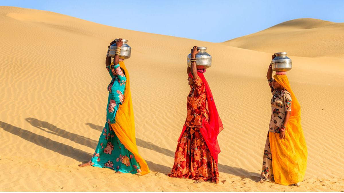 Women carrying on their heads water from local wells. (Photo: iStockphoto)