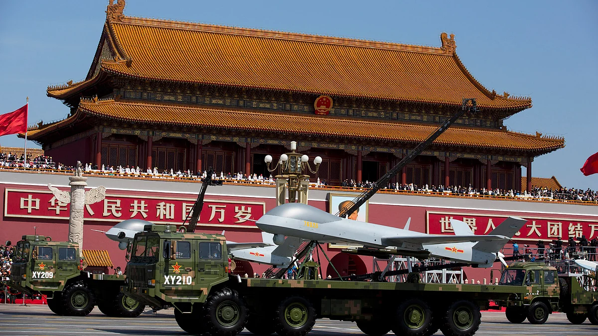 Military vehicles carrying Wing Loong, a Chinese made medium-altitude long-endurance unmanned aerial vehicle, drive past Tiananmen Gate during a military parade in Beijing, 3 September 2015. (Photo: AP)