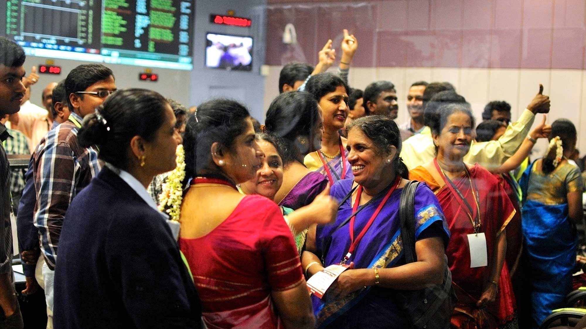 Indian Space Research Organization (ISRO) women scientists and engineers cheer after India’s Mars orbiter successfully entered the red planet’s orbit, at their Spacecraft Control Center, in this photo taken through a glass panel, in Bangalore on 24 September 2014. (Photo: Reuters)