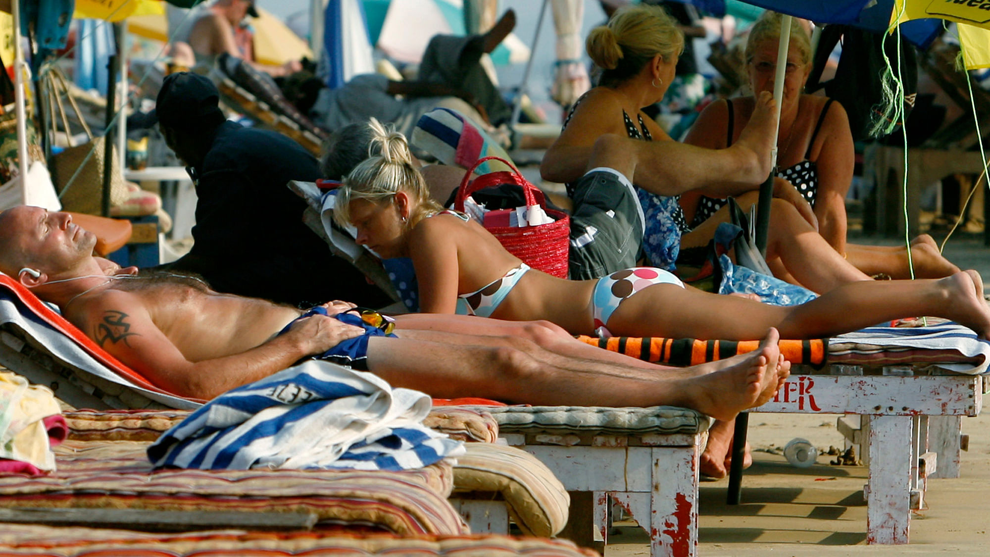 Tourists relax at the Baga beach in Goa. (Photo: Reuters)