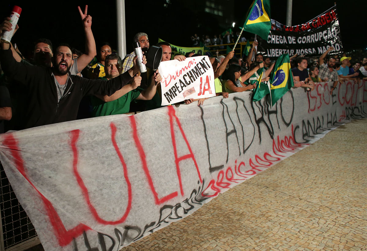 Thousands of supporters clad in red marched for President Rousseff.