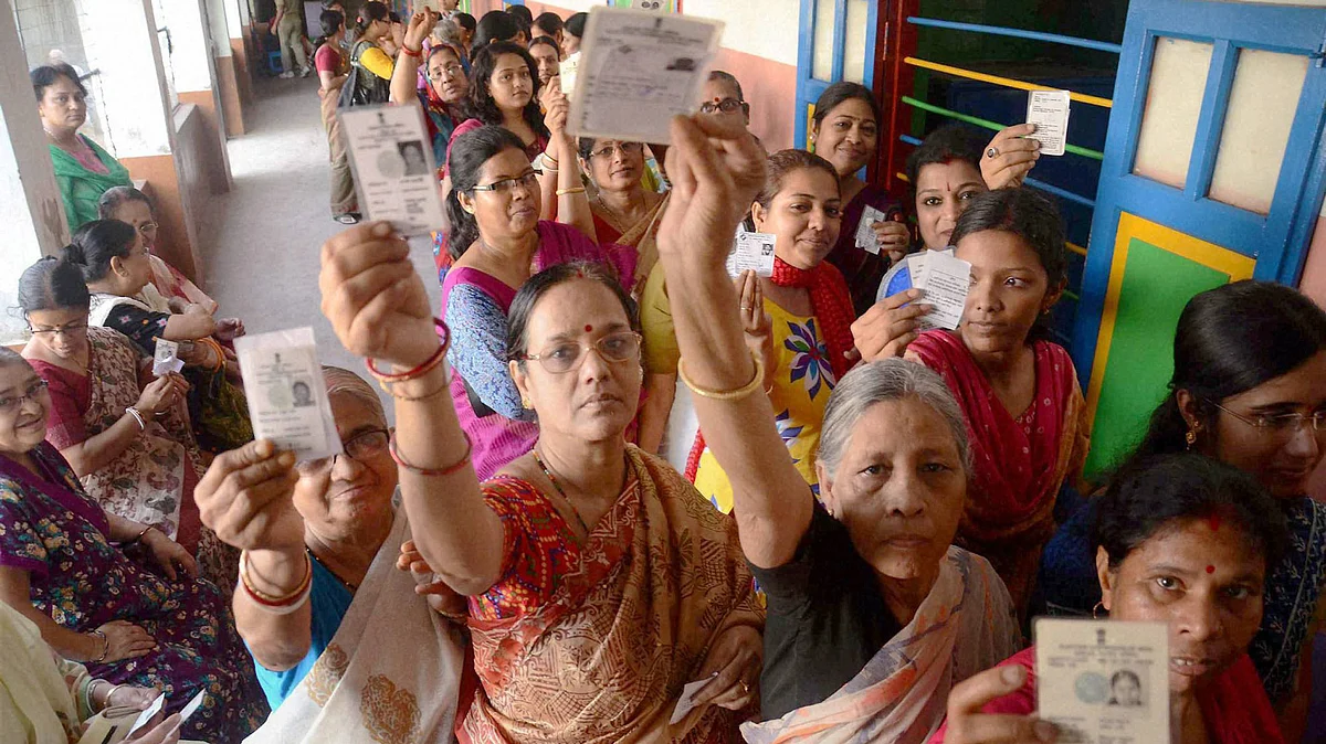 Women showing their voter cards during the 1st phase of West Bengal Assembly Elections in West Medinipur