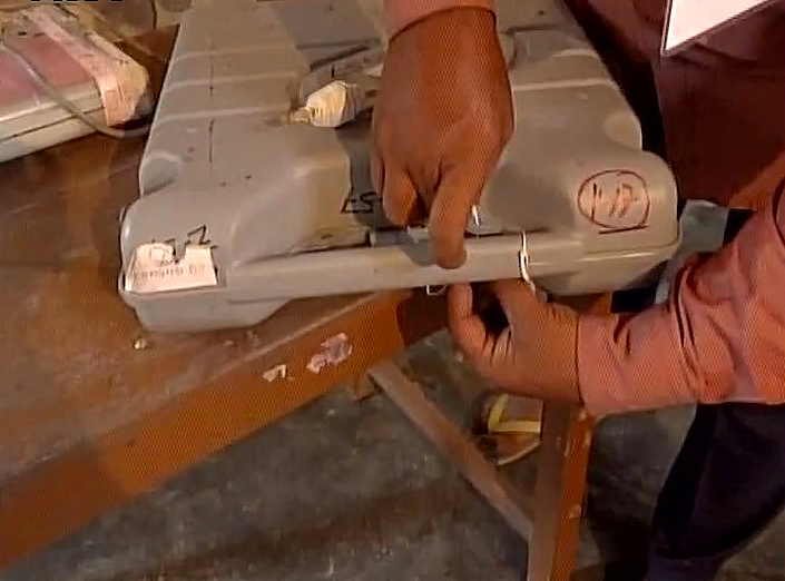 Officials sealing the Electronic Voting Machine (EVM) until the counting. (Photo Courtesy: ANI)