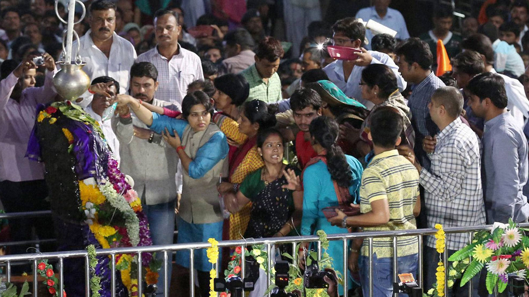 Activist Trupti Desai (in blue, center) offering prayer at the Shani Shingnapur temple after the gates were opened for women, in Ahmednagar on Friday, 8 April 2016. (Photo: PTI)  &nbsp;