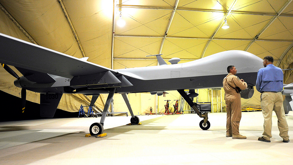 US Air Force Lt Col Morgan Curry briefs Deputy Secretary of Defense William J Lynn III on the capabilities of a Predator unmanned aerial vehicle at Kandahar Air Field, Afghanistan, Sept. 10, 2009. (Photo Courtesy: <a href="https://www.flickr.com/photos/39955793@N07/3910234448/">defense.gov</a>)