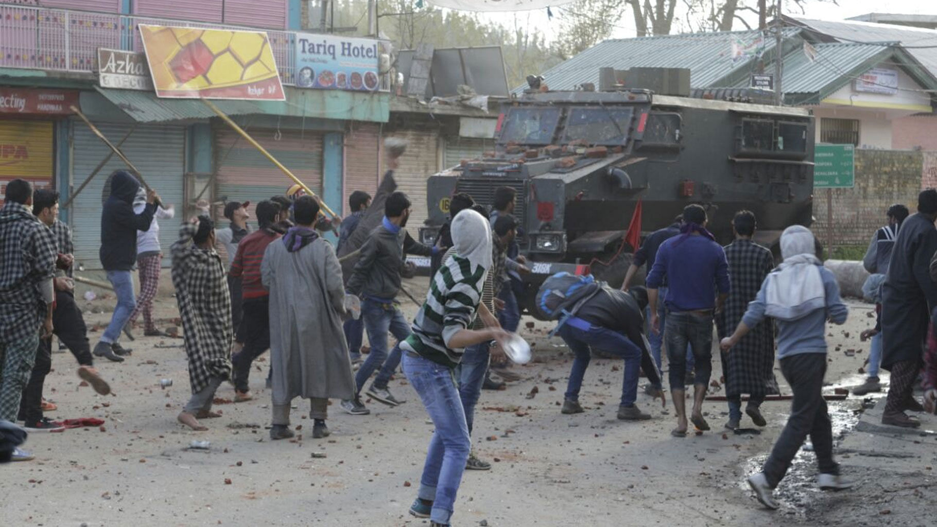 People pelt stones on an army vehicle a day after two people were killed in a army firing in Handwara of Jammu and Kashmir on Tuesday, 13 April 2016. (Photo: IANS)