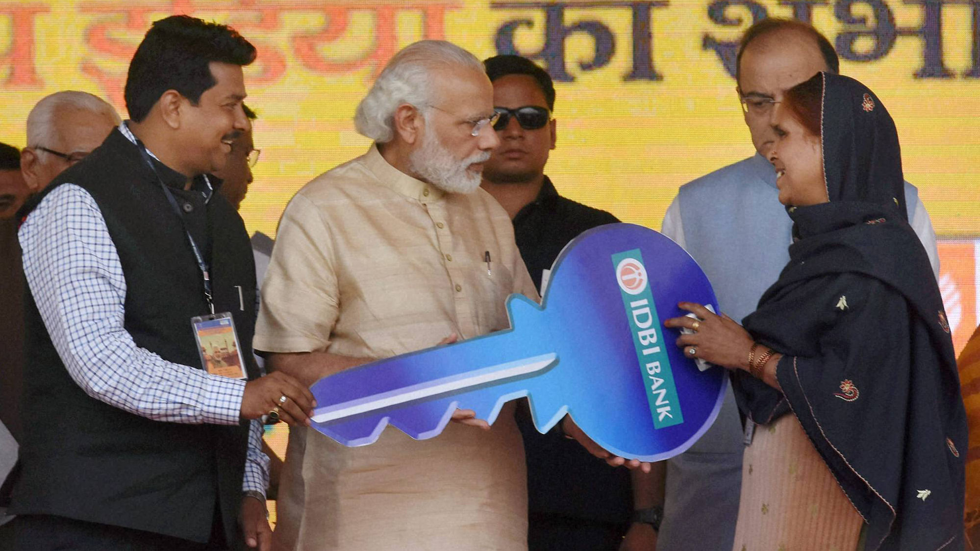 Prime Minister Narendra Modi hands over the keys of an e-rickshaw to a beneficiary under Pradhan Mantri Mudra Yojana launched under Stand up India Scheme in Noida on Tuesday. (Photo: PTI)