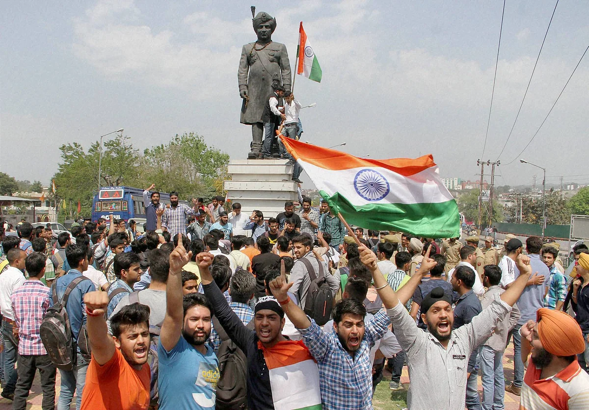 Non-Kashmiri students raising the tricolour. (Photo: PTI)