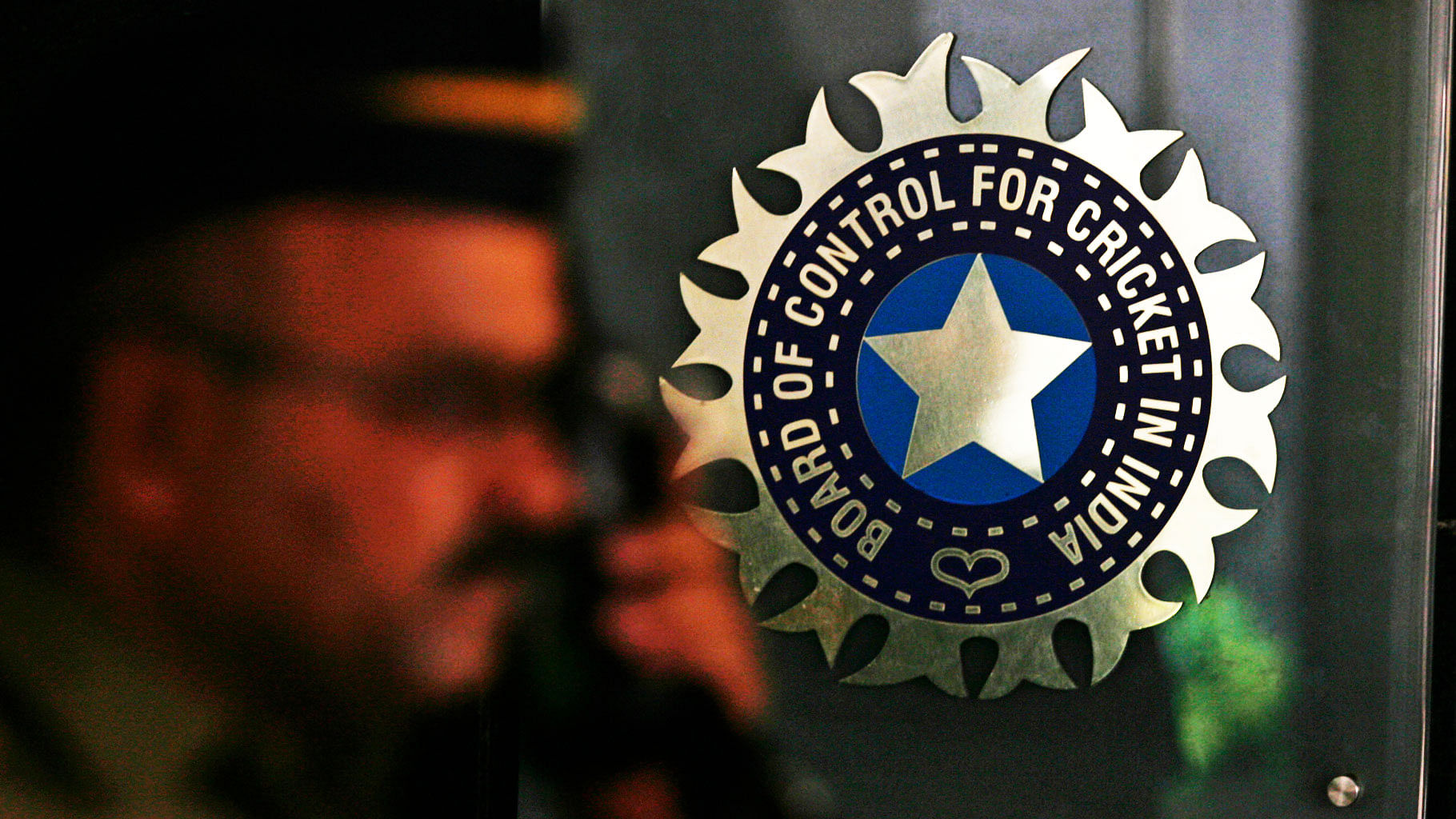 A policeman standing in front of the BCCI logo. (Photo: Reuters)