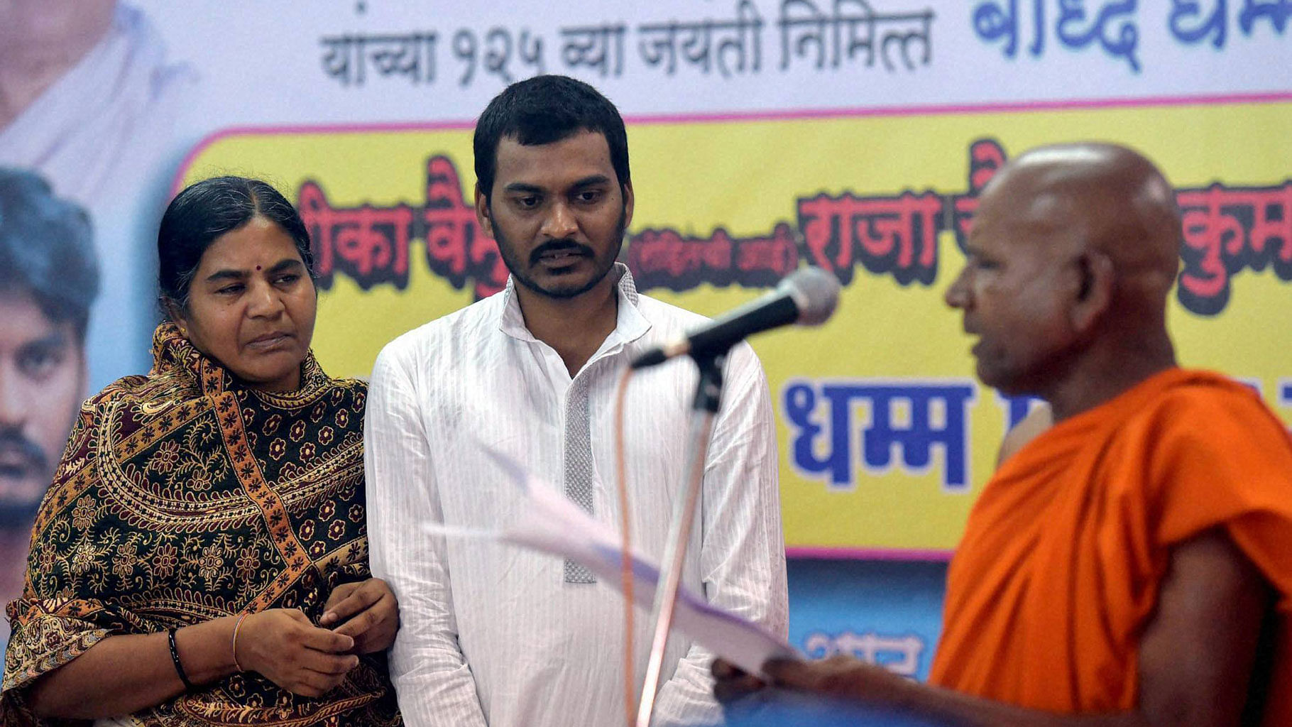 Rohith Vemula’s mother and brother embrace Buddhism on Thursday in Dadar, Mumbai. (Photo: PTI)