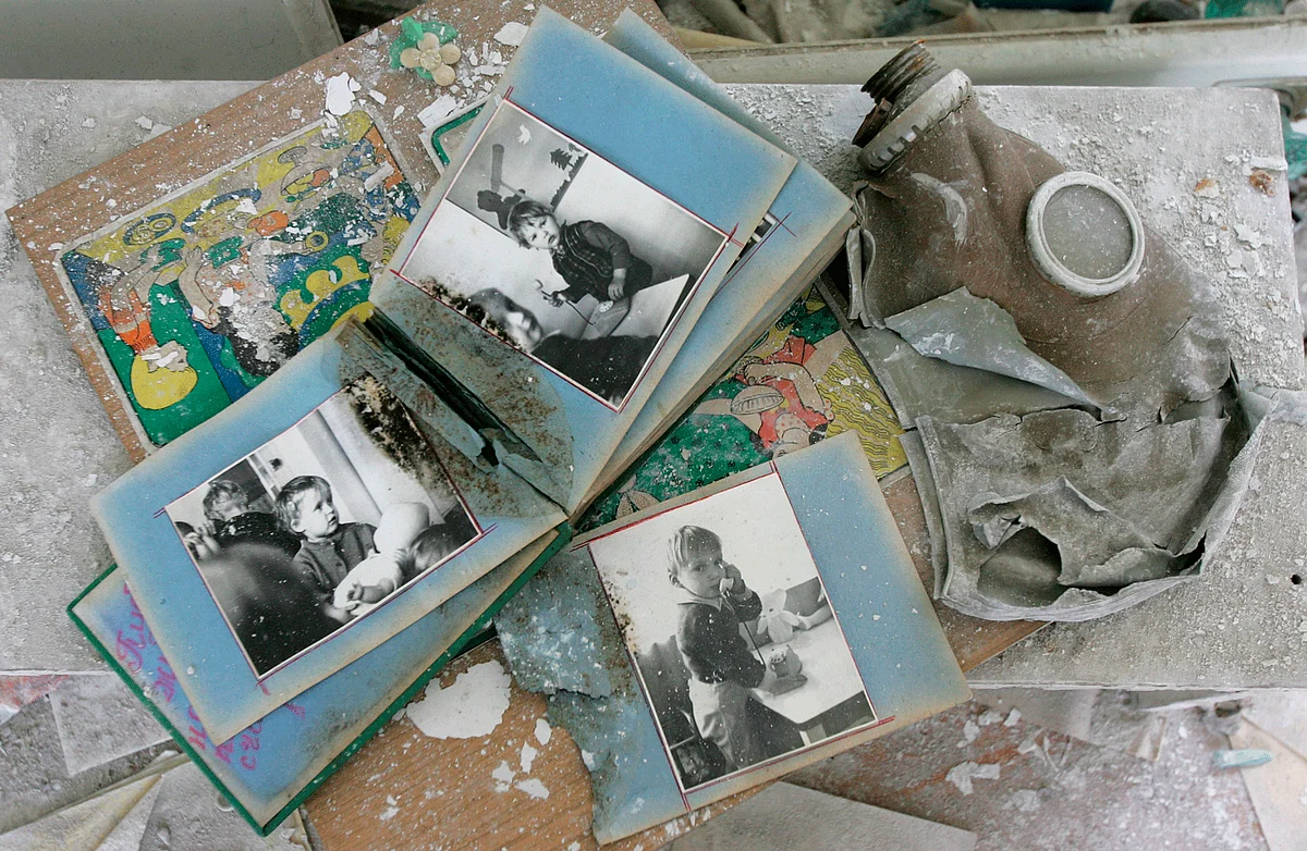 A family’s photo album collects dust and debris, 30 years after the Chernobyl Nuclear Disaster. It lies next to an ominous gas mask, common in nuclear townships in USSR. (Photo: Reuters)