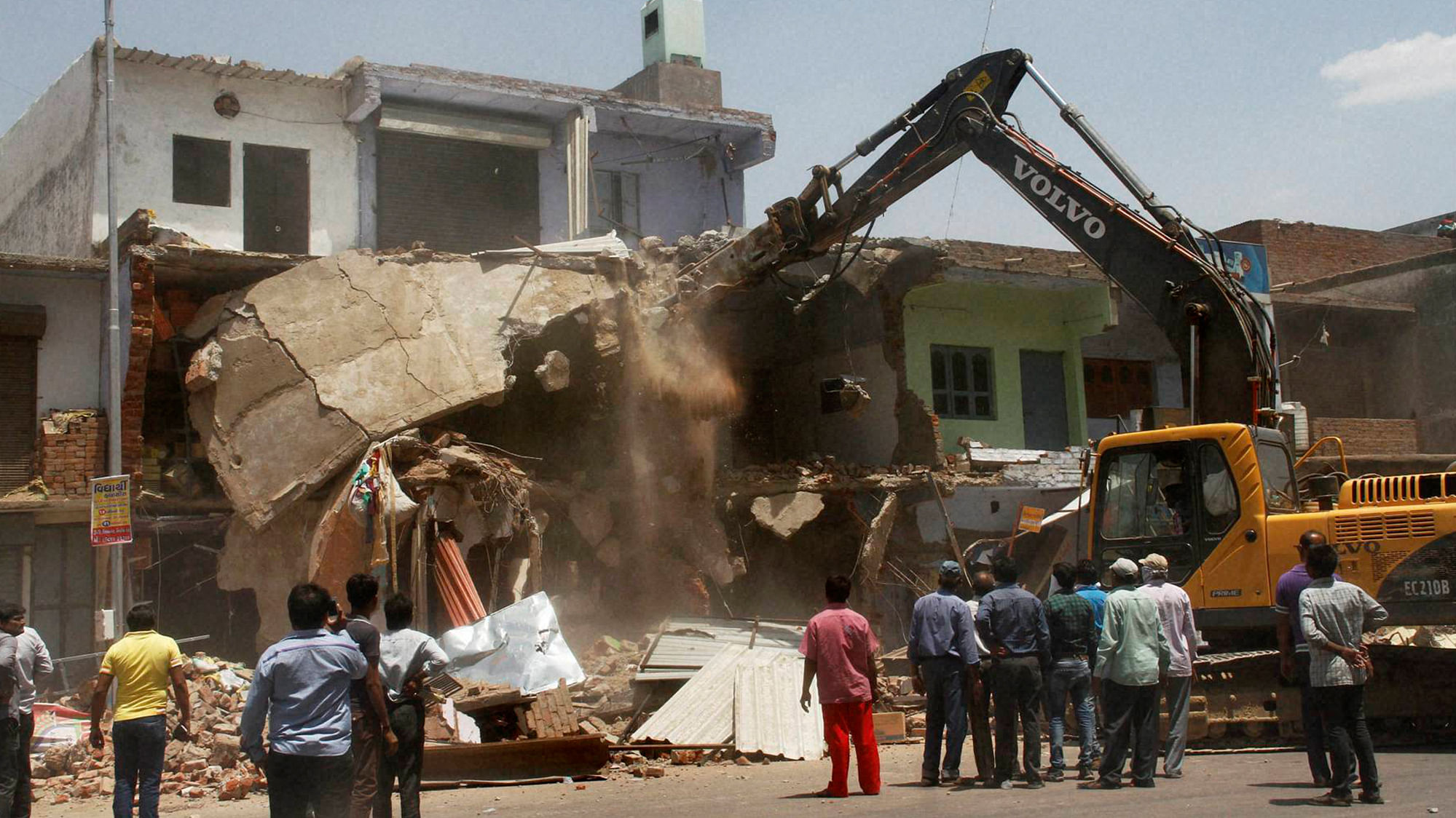 Municipal Corporation carrying out a demolition drive at Nikol area in Ahmedabad on Tuesday. (Photo; PTI)