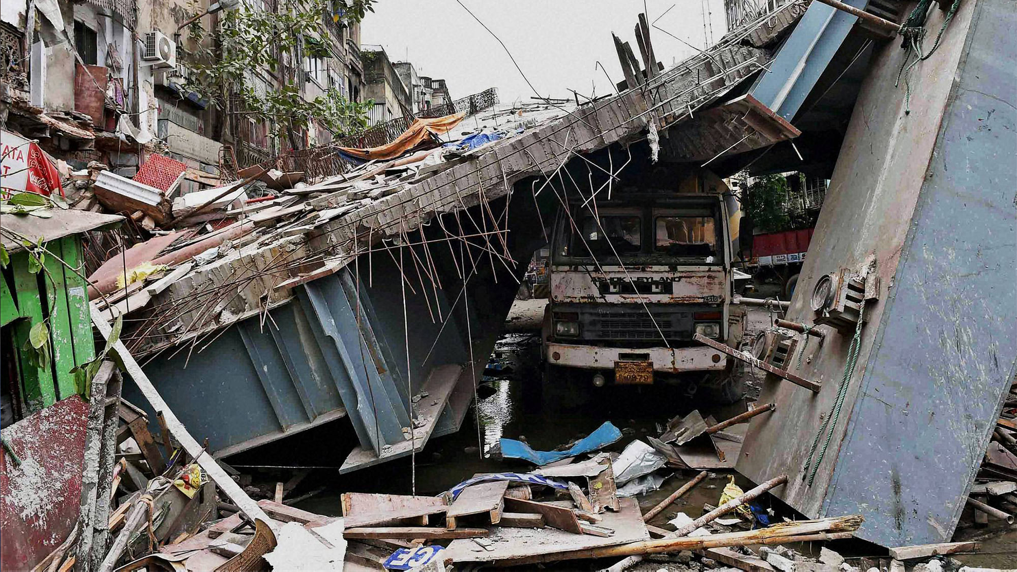 A truck trapped at the spot where an under-construction flyover collapsed on Vivekananda Road in Kolkata on Friday. (Photo: PTI)