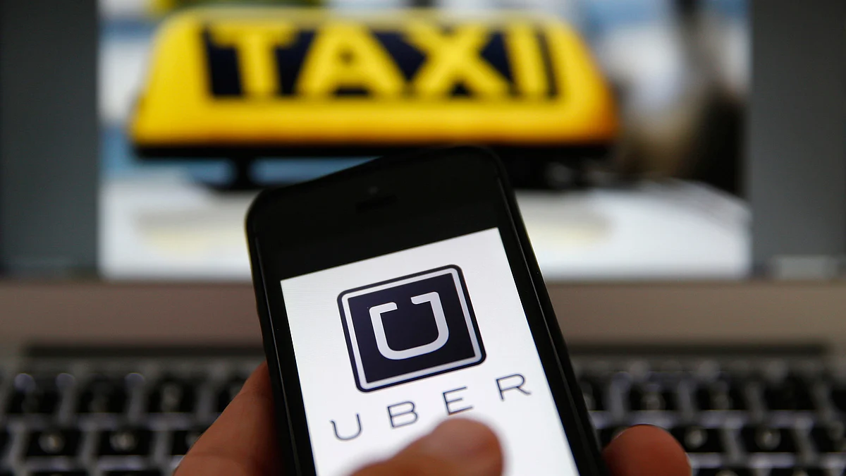 Logo of cab-aggregator service app Uber on a smartphone. 