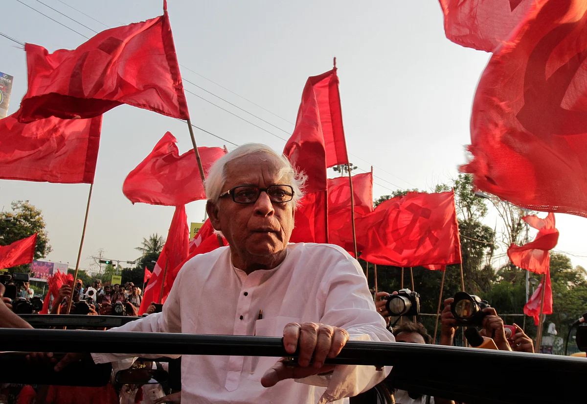Communist Party of India-Marxist (CPI-M) leader Buddhadeb Bhattacharya, surrounded by party flags travels on an open hood vehicle during an election rally, in Kolkata.(Photo: AP)
