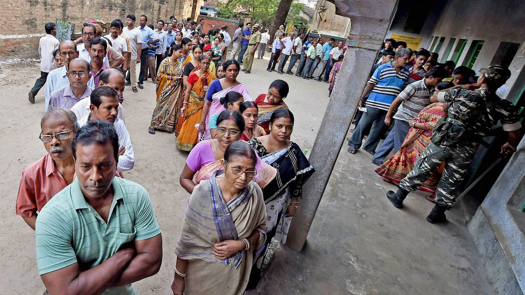 Voters stand in a queue to cast vote at a polling booth during 4th phase of the West Bengal assembly polls in Howrah on Monday. (Photo: PTI)