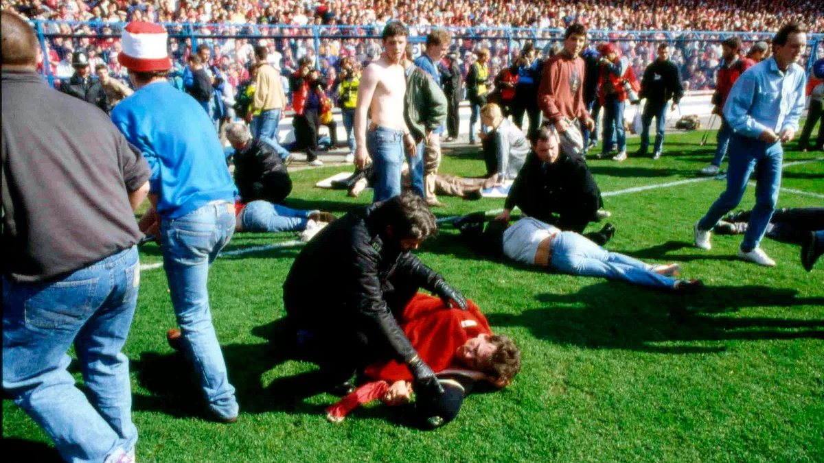 In this April 15, 1989 file photo police, stewards and supporters tend and care for wounded supporters. (Photo: AP)