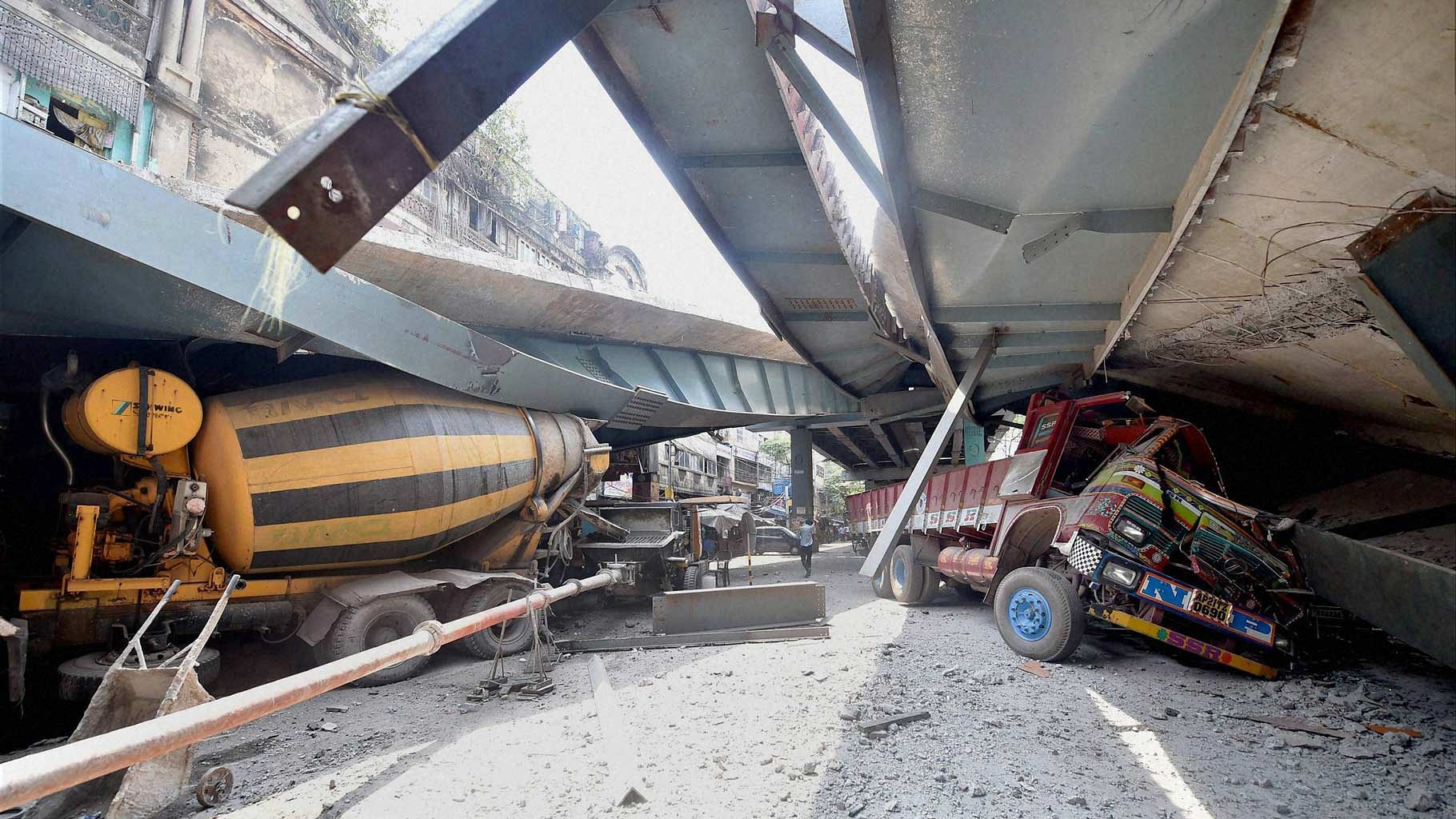 Heavy vehicles crushed as an under-construction flyover collapsed on Vivekananda Road in Kolkata on Thursday. (Photo: PTI)