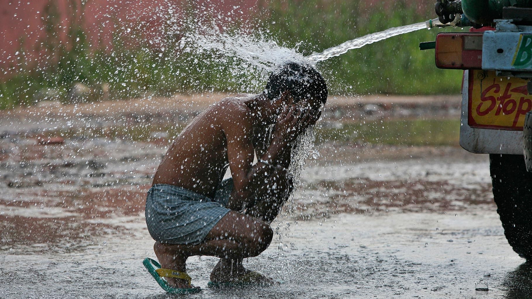 A child cools off in the sweltering heat.&nbsp;