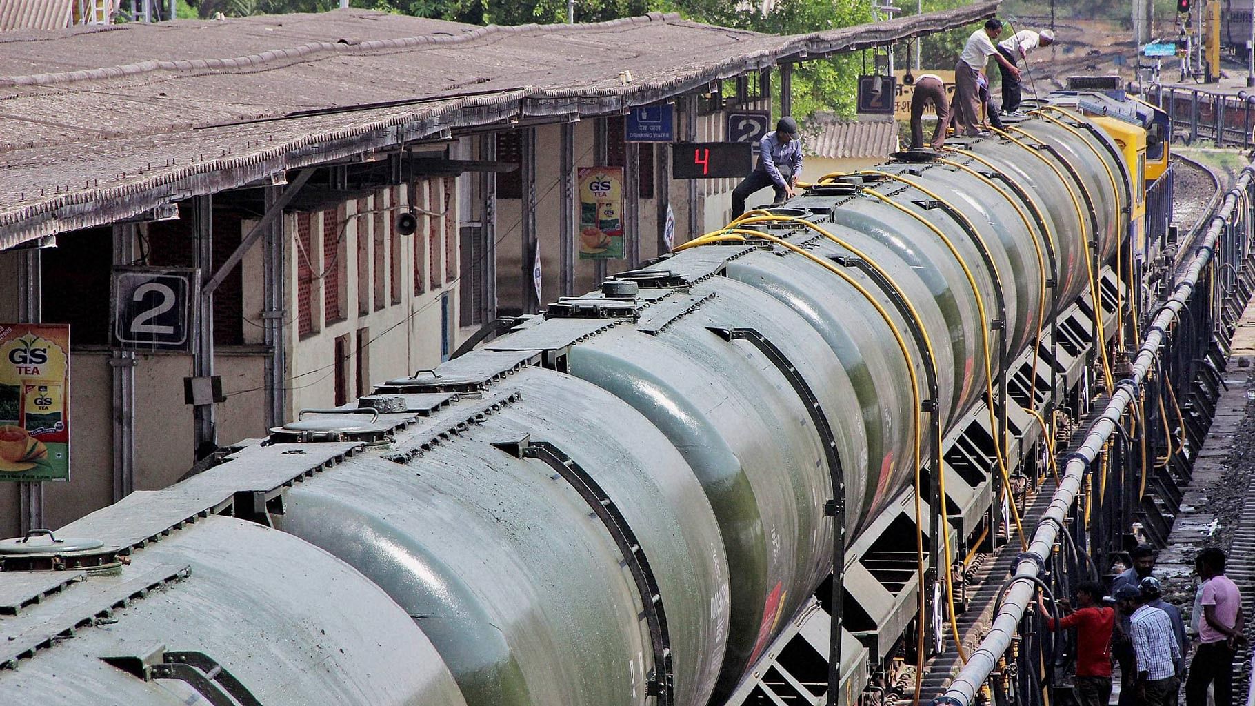 Workers fill water in Central Railway train tanks to transport to drought-affected Latur District from Miraj station near Sangli on Sunday. (Photo: PTI)