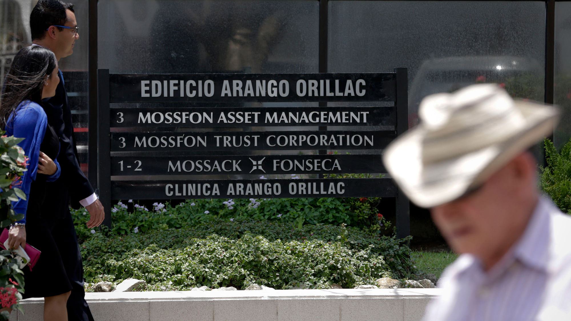 People walk past the Arango Orillac Building which lists the Mossack Fonseca law firm in Panama City on Tuesday, 5 April  2016. (Photo: AP)