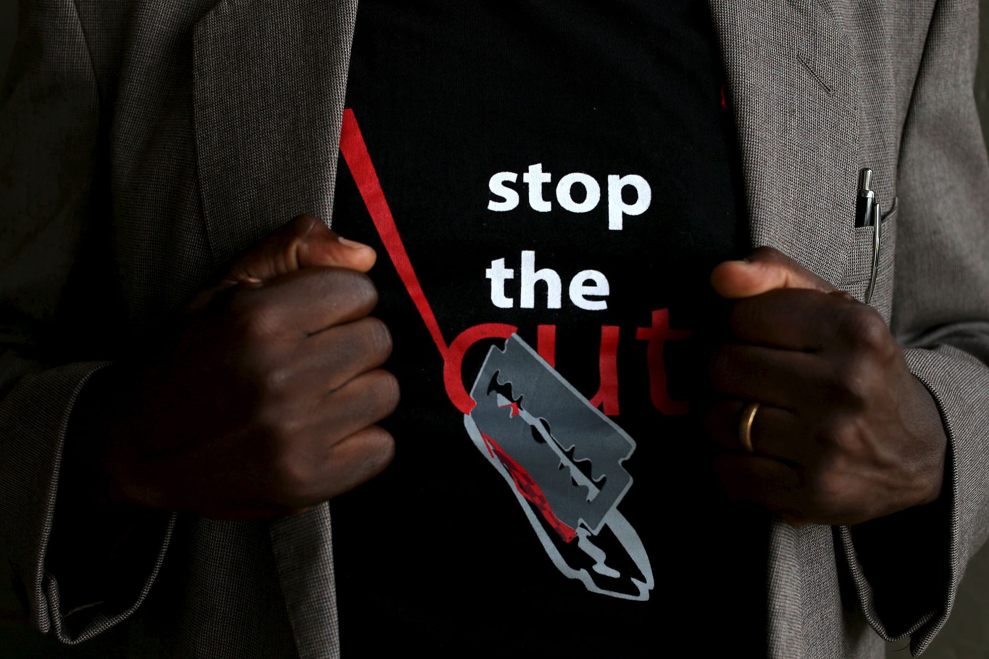 A man shows the logo of a T-shirt that reads “Stop the Cut” referring to Female Genital Mutilation  during a social event in Kenya in April 2016. (Photo: Reuters)