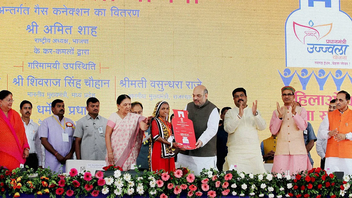 BJP President Amit Shah giving away an LPG connection to a tribal woman under Pradhan Mantri Ujjwala Yojana in Dahod district in Gujarat, May 15, 2016. (Photo: PTI)