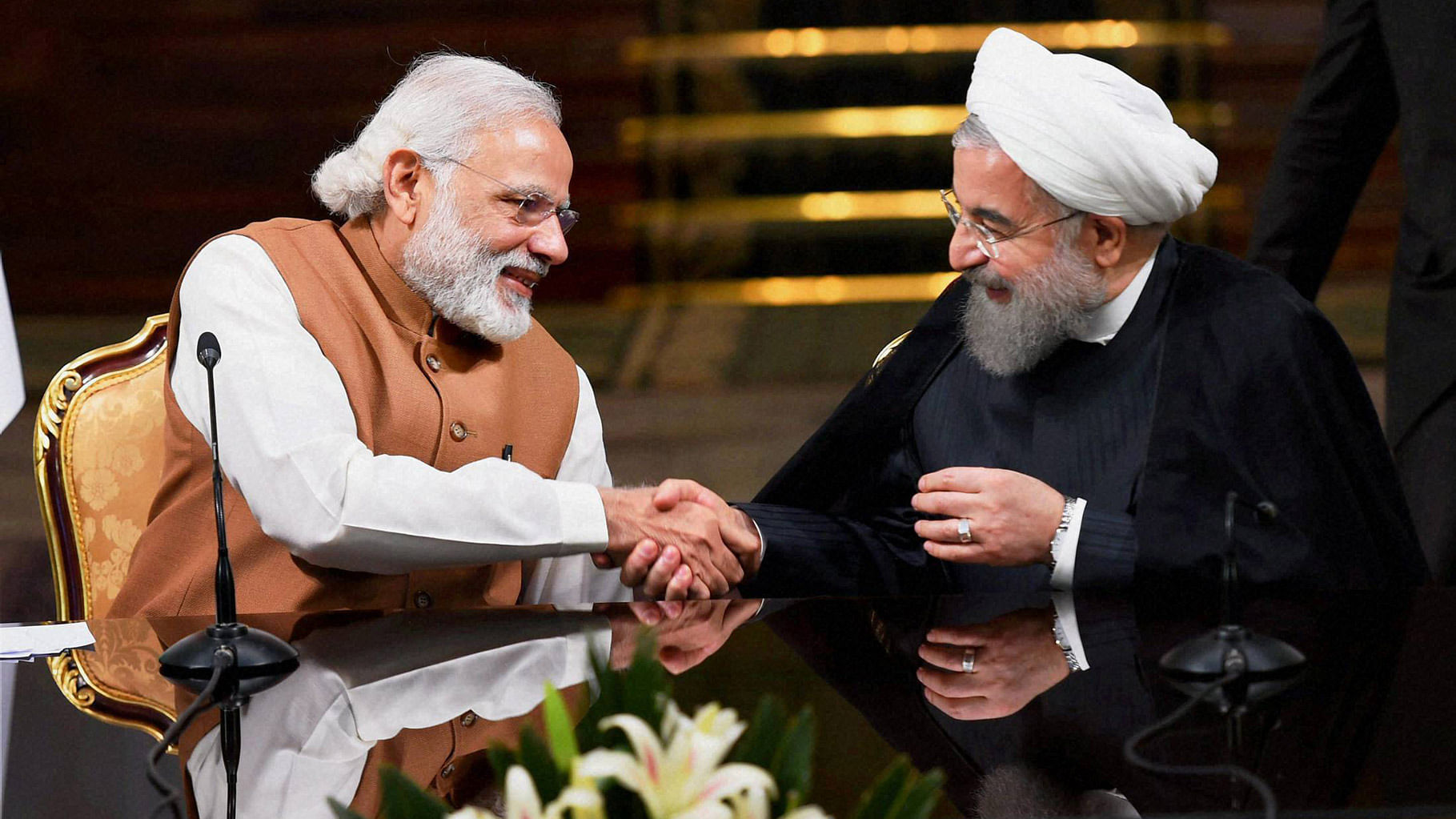 Prime Minister Narendra Modi shakes hands with Iranian President Hassan Rouhan during a joint press conference after their meeting at the Saadabad Palace in Tehran, Iran, Monday. (Photo: PTI)
