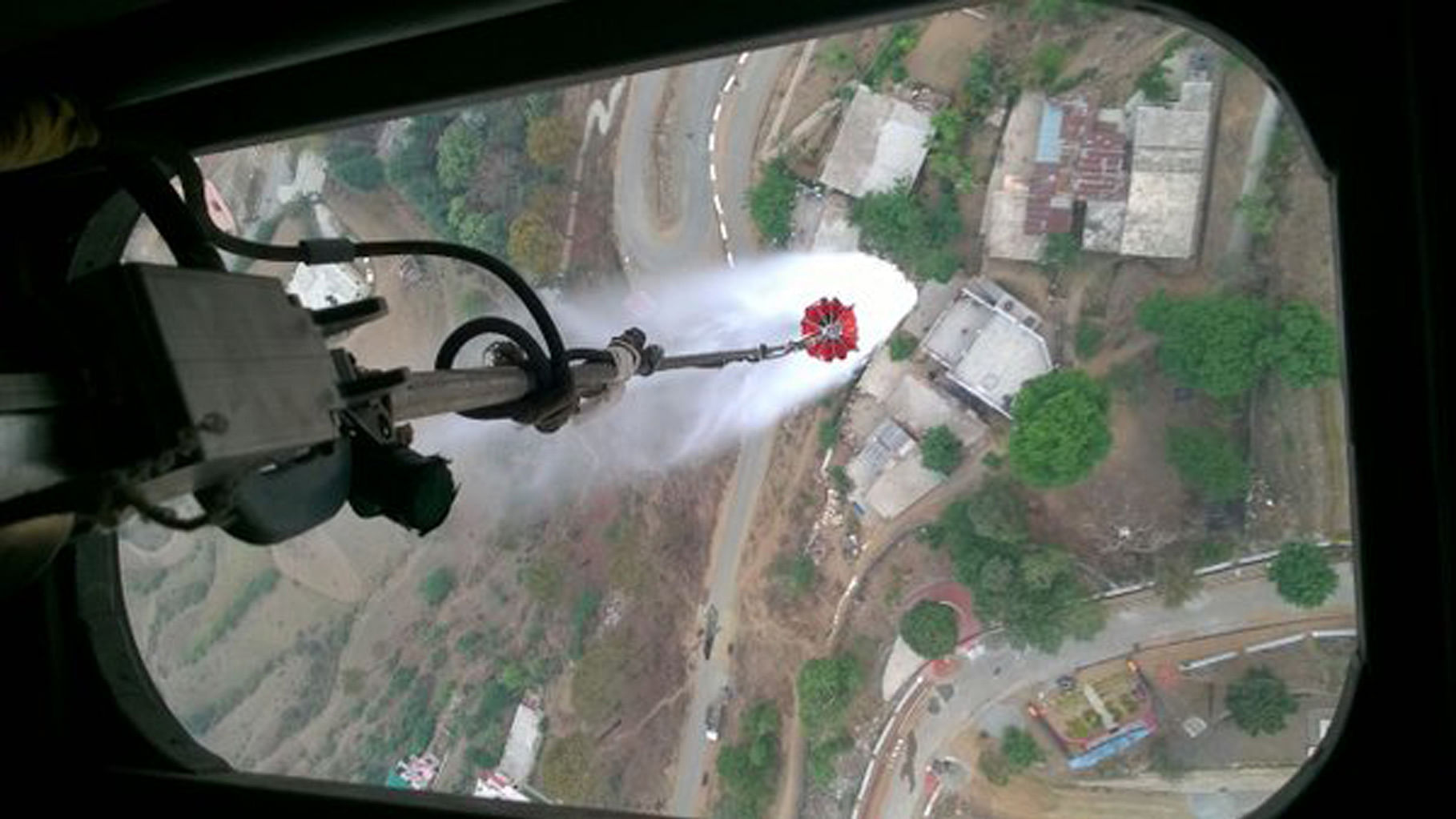 Water being sprayed on a forest in Uttarakhand from a helicopter. (Photo: PIB India/twitter) Twitter reac