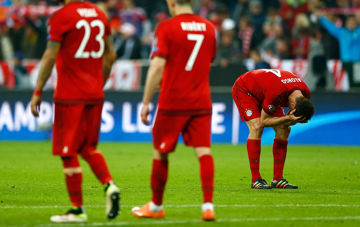 Bayern’s players leave the pitch as Atletico players celebrate after advancing to the final. (Photo: AP)