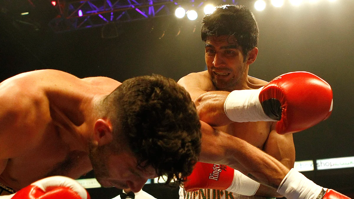 Vijender Singh throws a right hook at Sonny Whiting during his first ever pro-boxing bout at Manchester Arena (Photo: Reuters)
