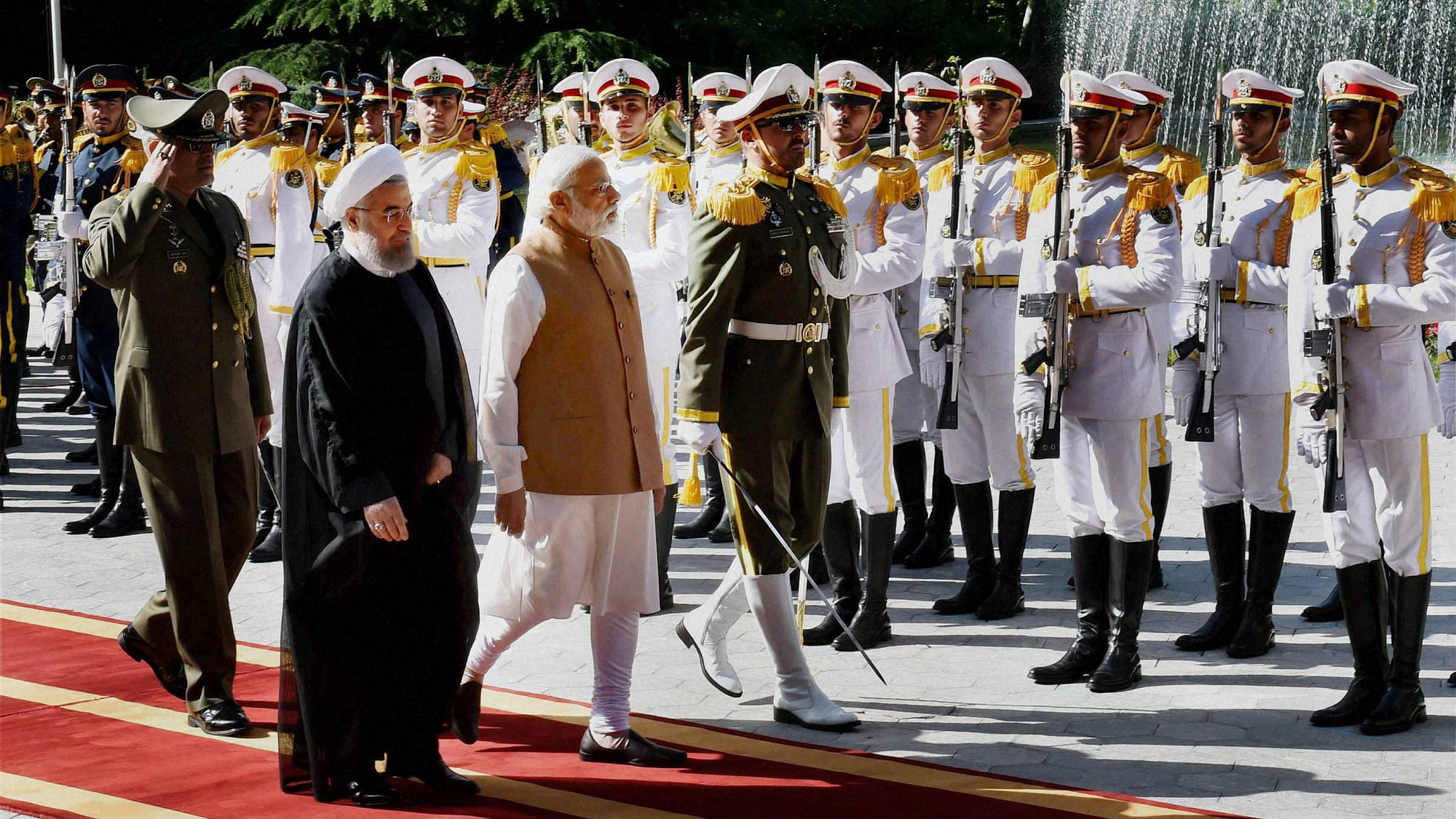 

Prime Minister Narendra Modi with Iranian President Hassan Rouhani reviewing guard of honour at the Saabad Palace in Tehran, Iran, on 23 May. (Photo Courtesy: PTI)