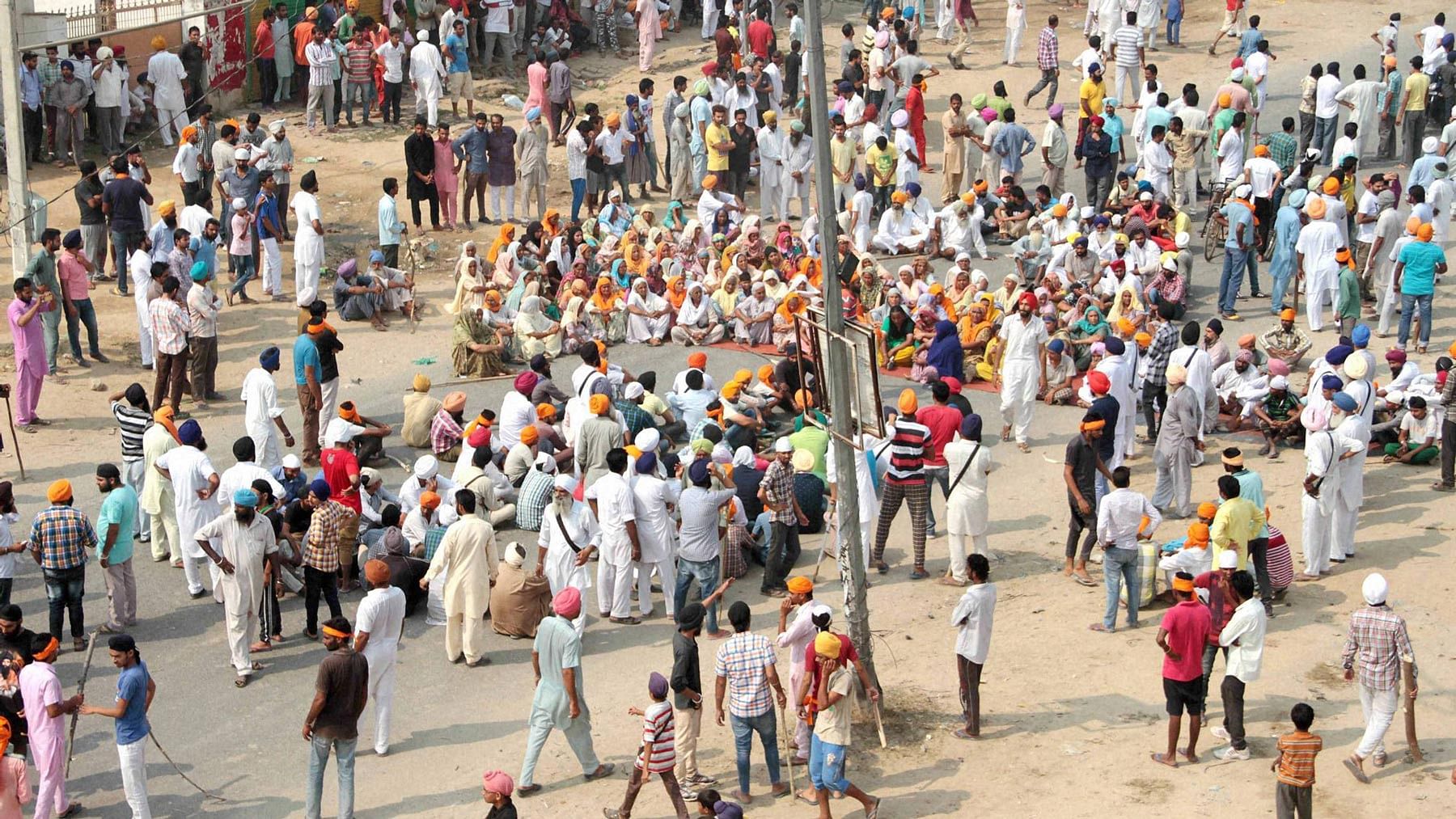 File photo of people gathered in Bathinda, Punjab to protest against the desecration of the holy book. (Photo: PTI)