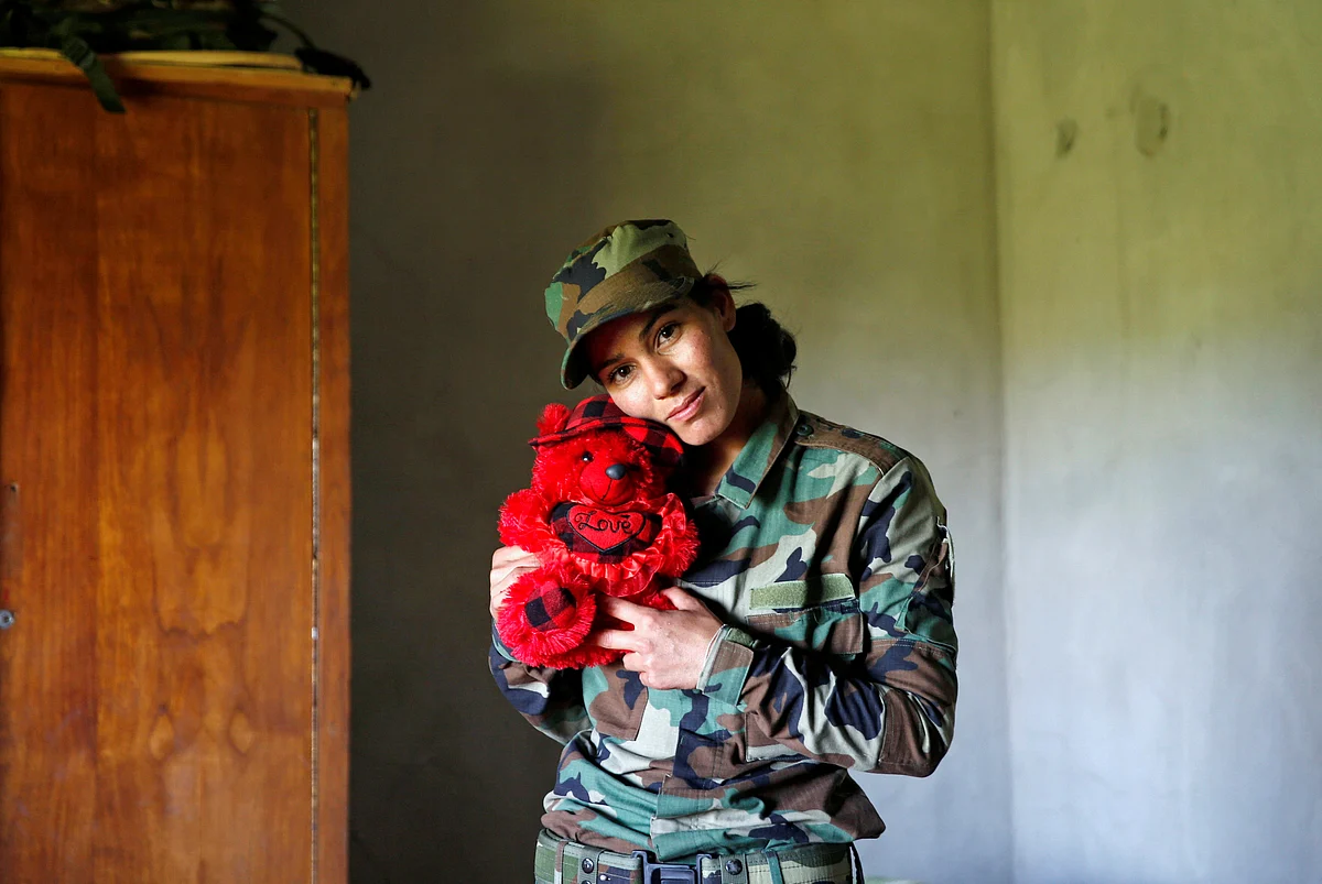 Yazidi female fighter Asema Dahir, 21, poses with a teddy bear in a bedroom at a site near the frontline of the fight against Islamic State militants in Nawaran near Mosul, Iraq. (Photo: Reuters)
