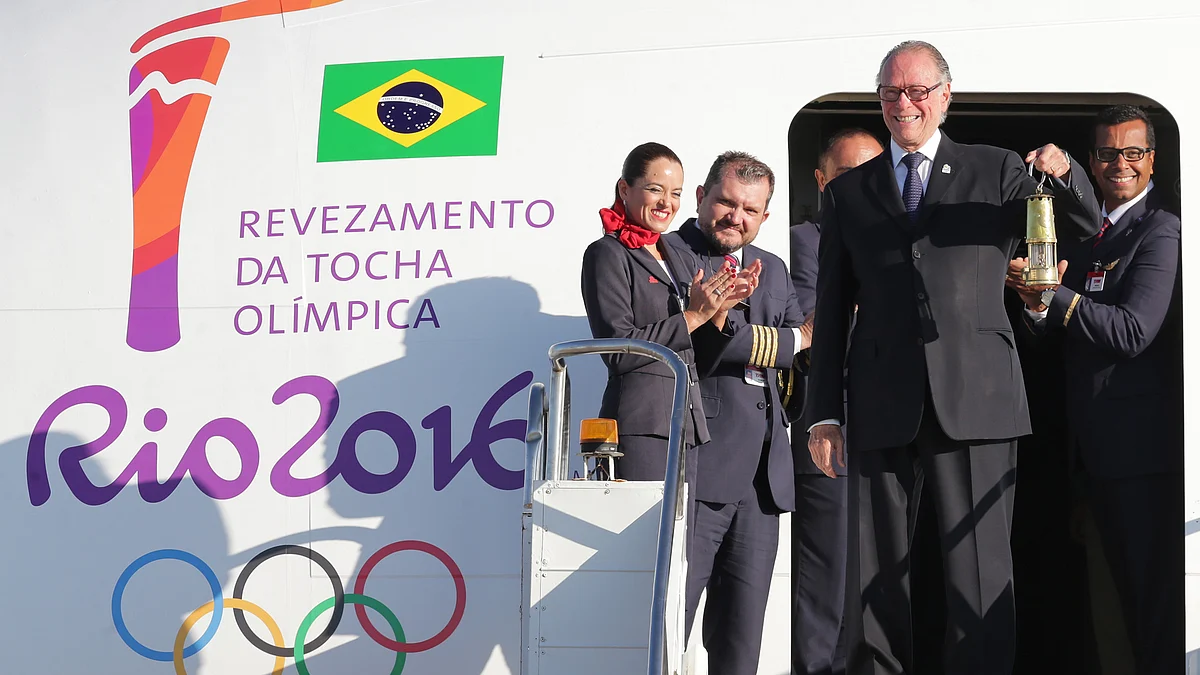 Brazilian Olympic Committee President with the lantern containing the Olympic flame as he deplanes in Brasilia, Brazil. It was flown inside a small lantern on a special flight from the Swiss city of Geneva to Brasilia. (Photo: AP)