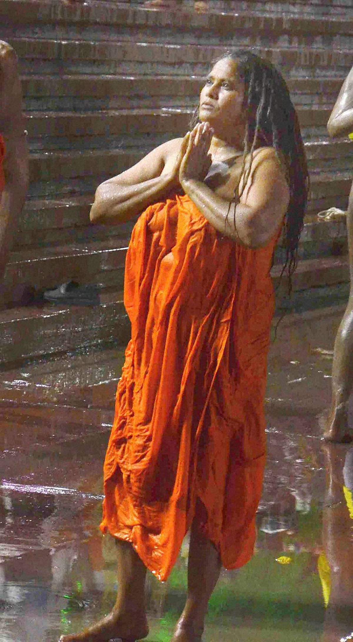 A sadhvi offering prayers while taking a holy dip on the last and third royal bath ( Shahi Snan) during Simhastha Maha Kumbh Mela in Ujjain. (Photo: PTI)