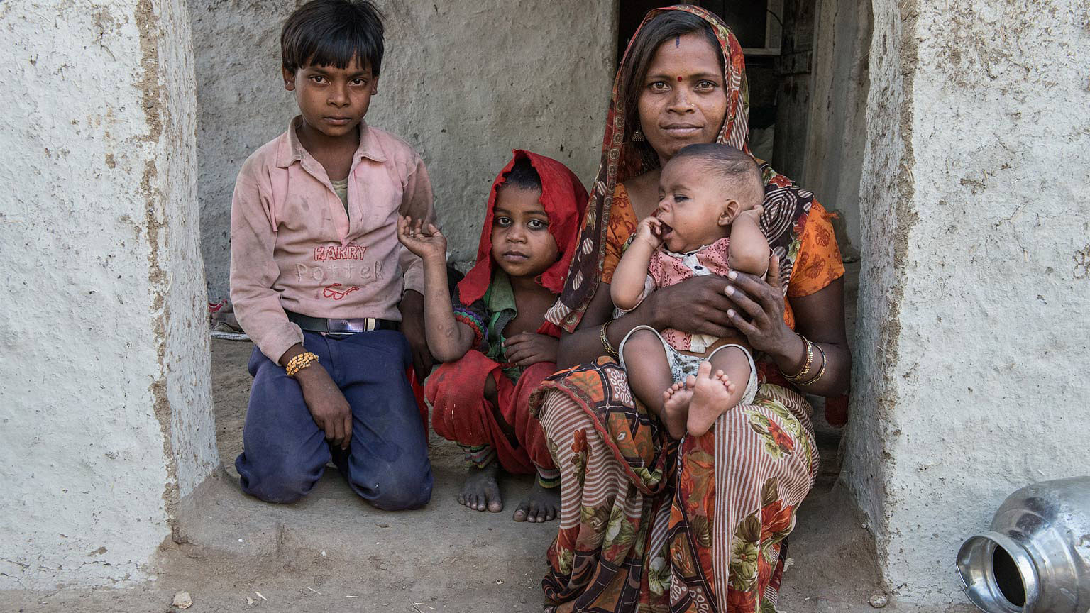 Kranti with her children in front of their home in Kajarai village. (Photo: World Vision India)