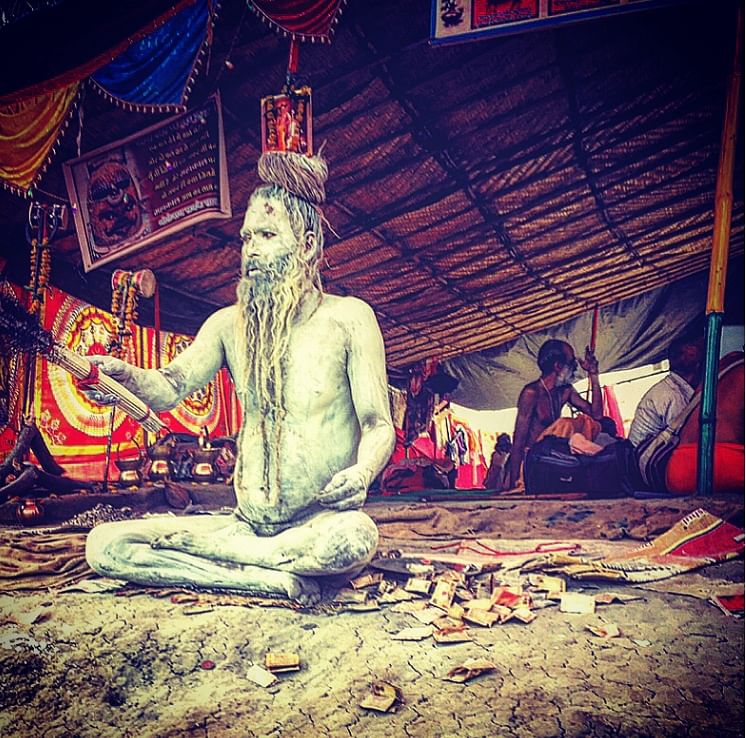 Nagasadhus smeared in ash sit with the ‘blessing broom’ at the Simhastha Ujjain Kumbh Mela 2016. (Photo: Rishika Baruah/The Quint)