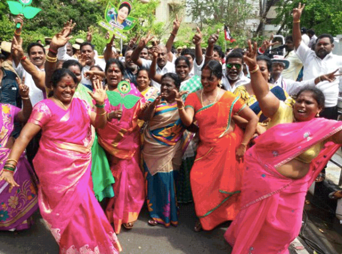  Supporters of the winning parties burst into color and dance as results of the polls were declared.
