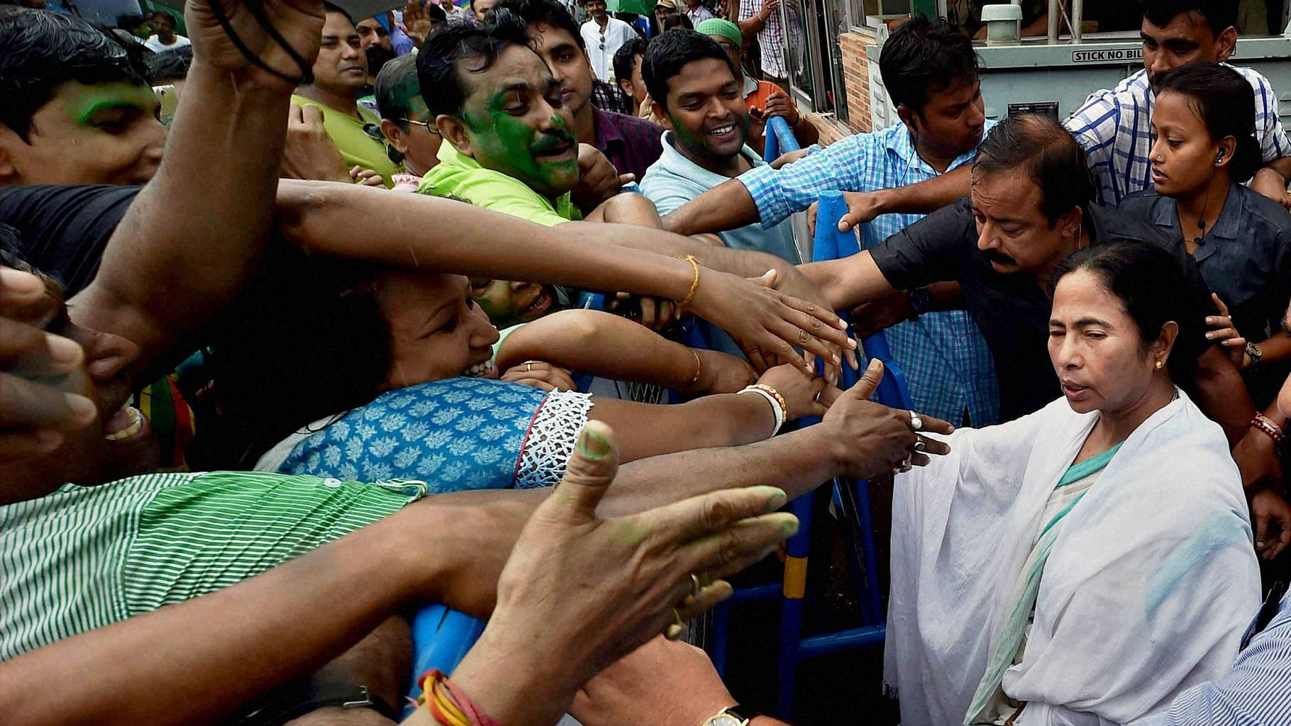 West Bengal CM Mamata Banerjee shaking hands with supporters after her party’s thumping win in West Bengal Assembly elections, in Kolkata on Thursday. (Photo : PTI)