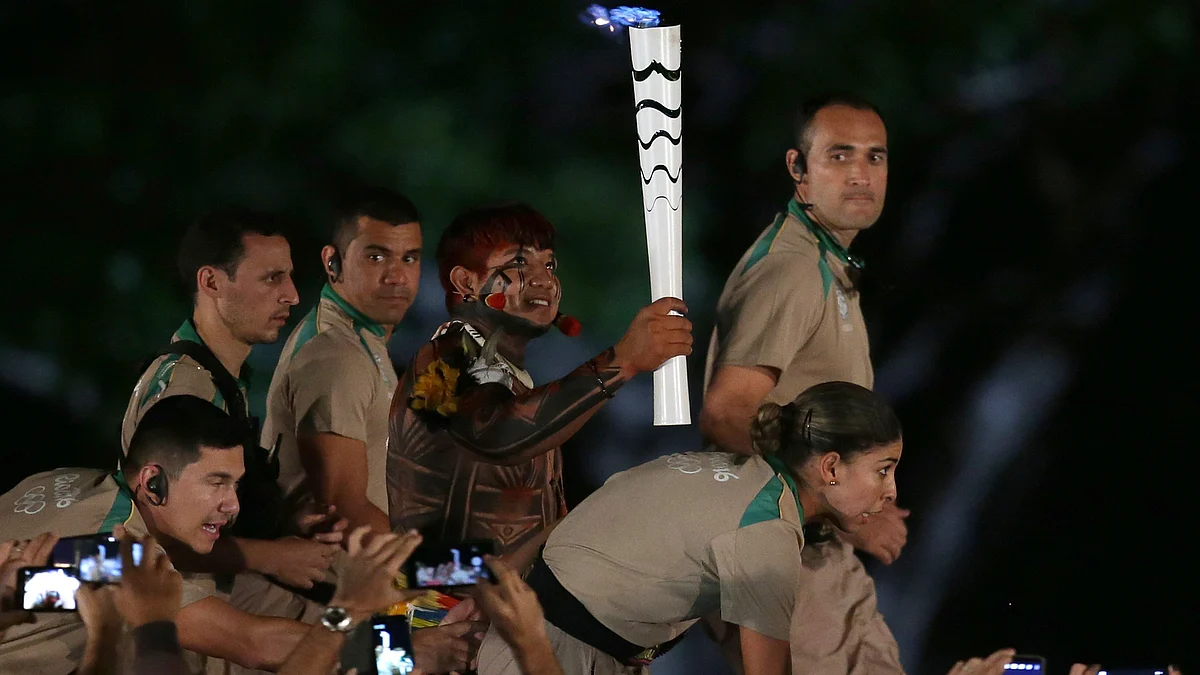 Brazil’s Indian athlete Kamukaika Lappa of the Yawalapiti ethnic group carries the Olympic torch during the torch relay in Brasilia. (Photo: AP)