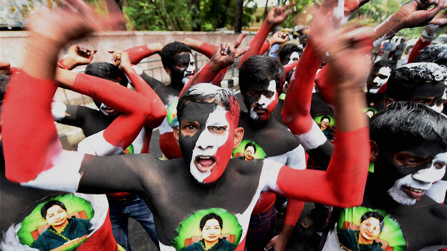 

AIADMK cadres, with their bodies painted, celebrate the party’s victory  outside Chief Minister J Jayalalithaa’s Poes Garden residence in Chennai on Thursday. (Photo: PTI)