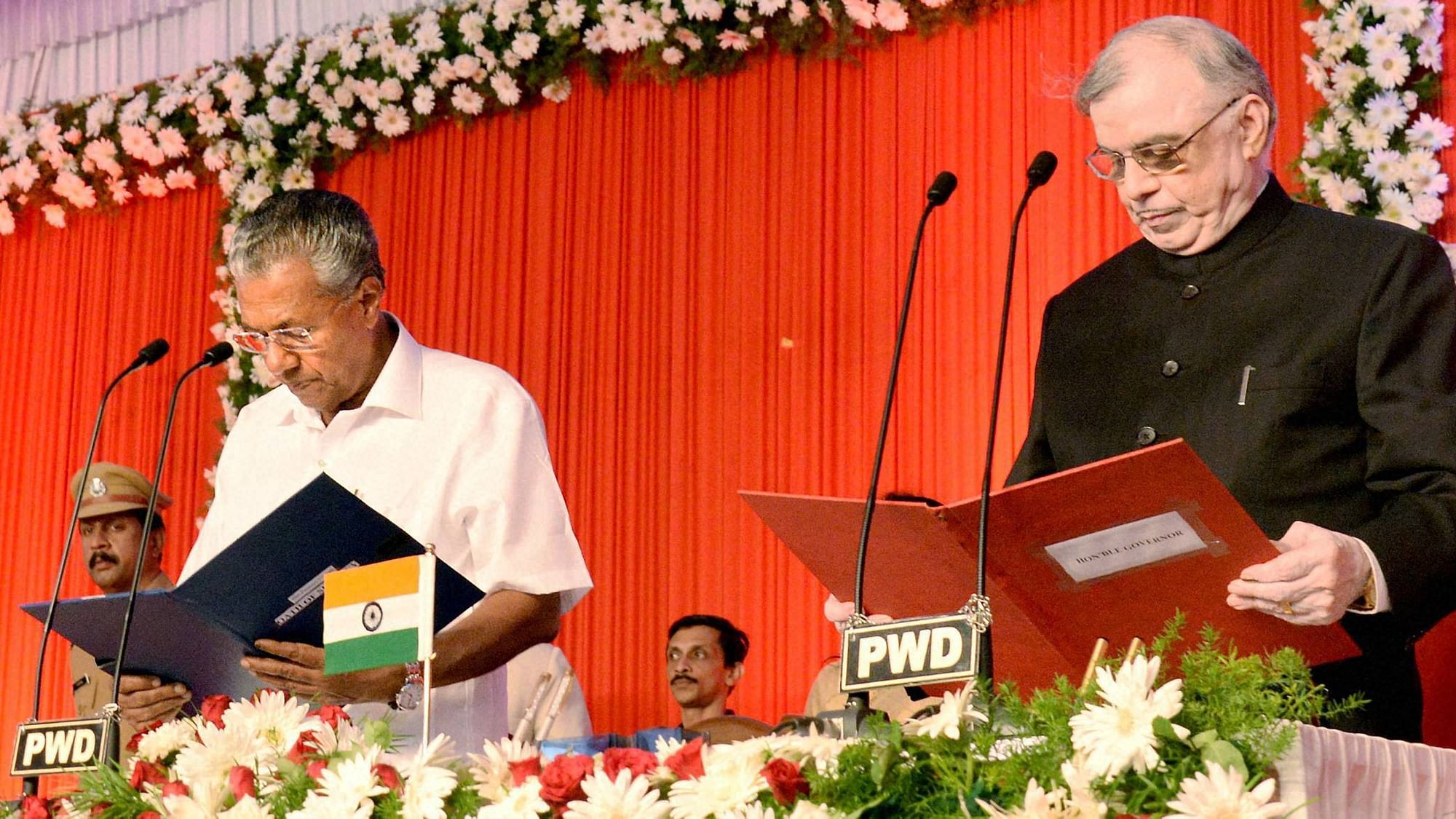 Kerala Governor P Sathasivam administers oath to Pinarayi Vijayan as the new Chief Minister of the state in Thiruvananthapuram on Wednesday. (Photo: PTI)
