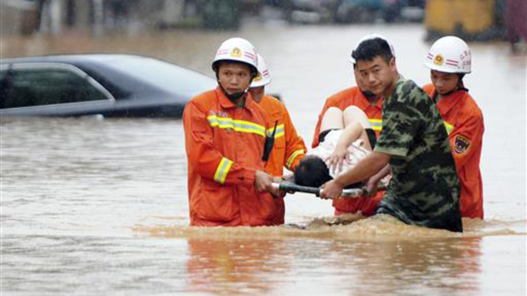 File photo of rescuers carry a woman on a stretcher through a flooded area in Jiujiang in southern China. Picture for representation purposes only.&nbsp;