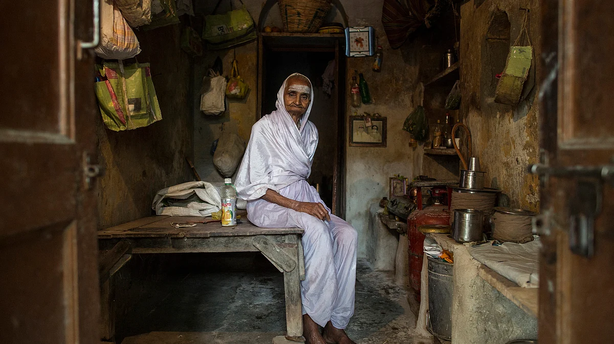 Savitri, an 80-year-old widow, poses for a photograph inside her room at Mumukshu Bhavan (Home of the Ailing) in Varanasi. (Photo: Reuters)