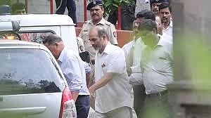 Virendra S Tawade being taken away after produced before the Sessions Court for alleged involvement in the 2013 murder of rationalist Narendra Dabholkar. (Photo: IANS)