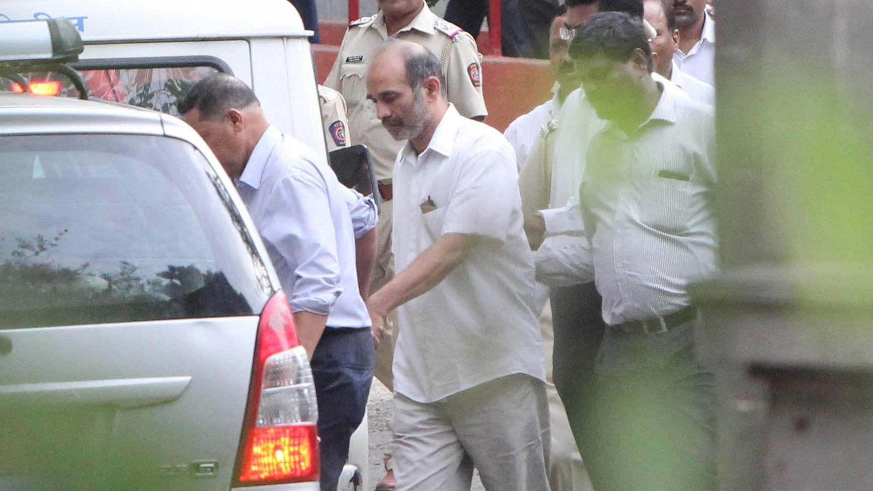 Virendra Tawde being taken away after he was produced in front of a Sessions Court.&nbsp;