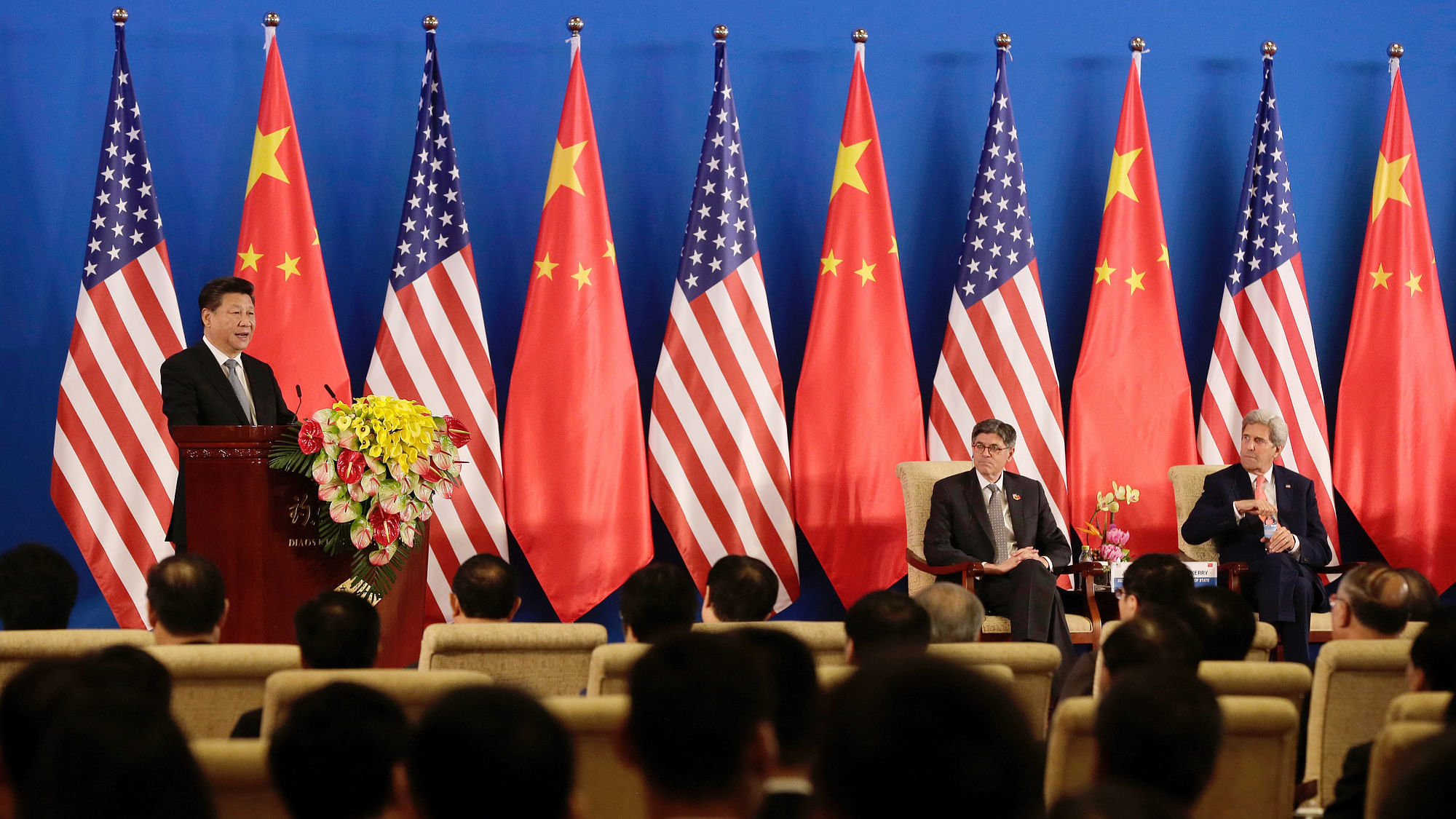 China’s President Xi Jinping speaks from the stage with US Secretary of State John Kerry (R) and US Treasury Secretary Jacob Lew. (Photo: AP)