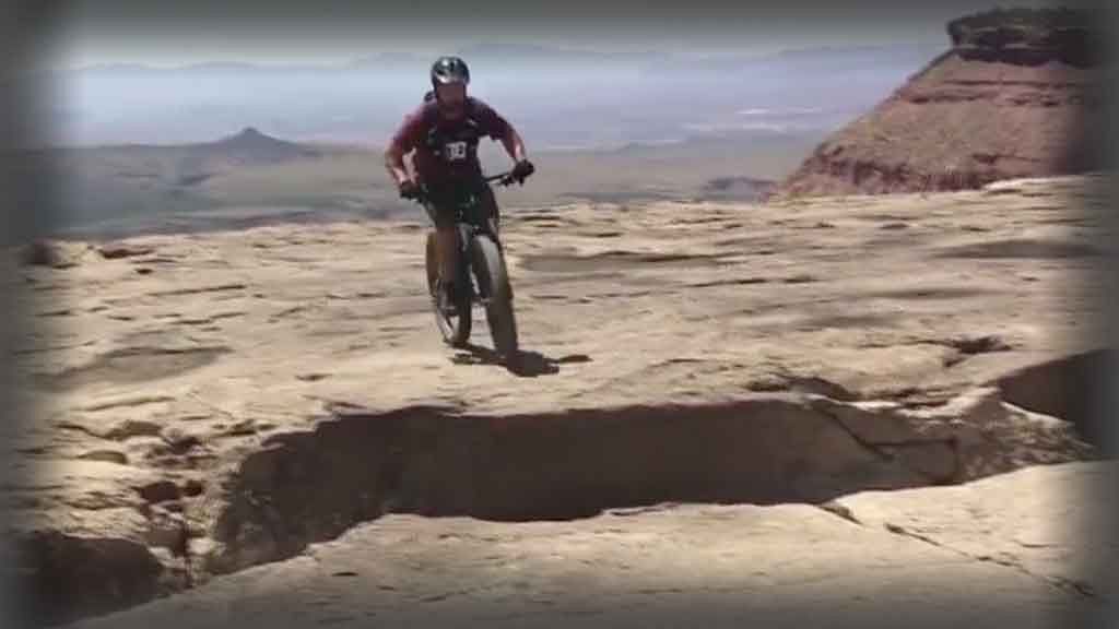 This guy decides to ride his bicycle along the edge of a cliff. (Photo:AP screen grab)